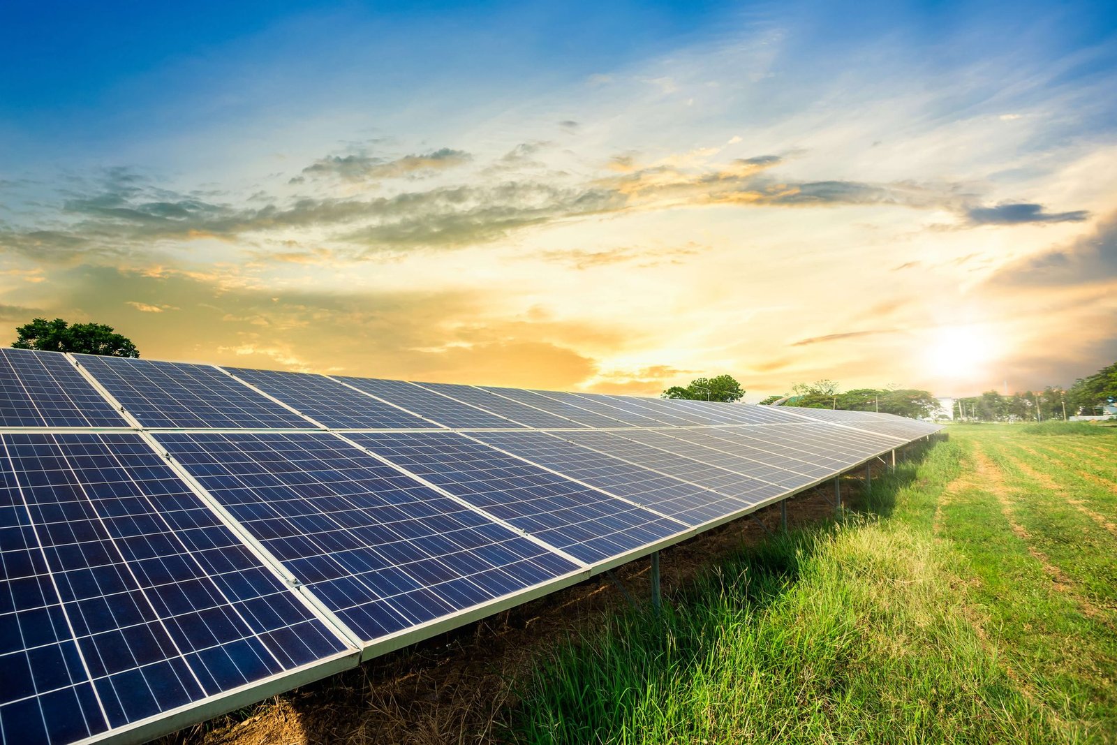 Solar panels against dramatic sunset sky showcasing PM Surya Ghar Yojana benefits